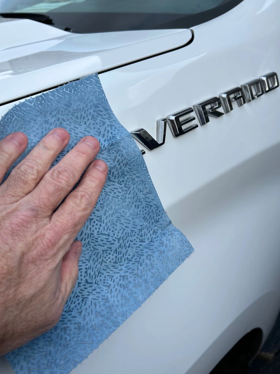 Brute Strength Wipes cleaning a vehicle badge during detailing work